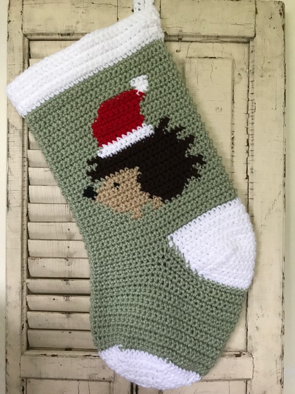 Hedgehog wearing a Santa hat crocheted Christmas stocking